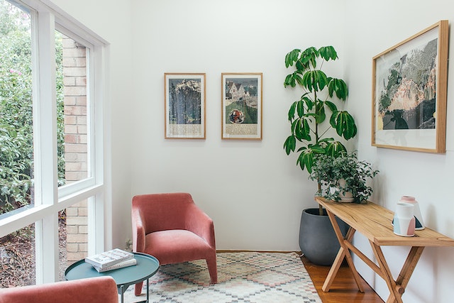  room with a large window and red furniture